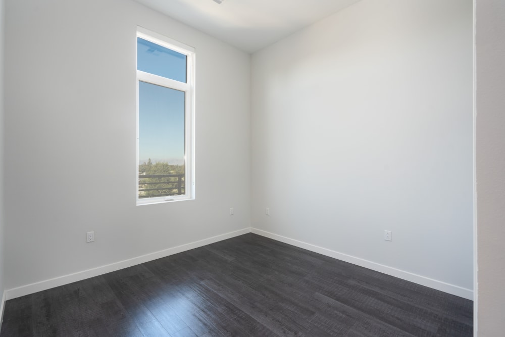 Bedroom with hardwood-style flooring in a penthouse at MV Apartments in Mountain View, California