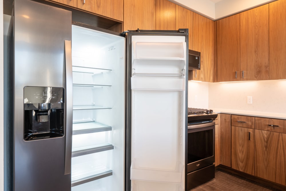 Chef-inspired penthouse kitchen with a stainless-steel refrigerator at MV Apartments in Mountain View, California