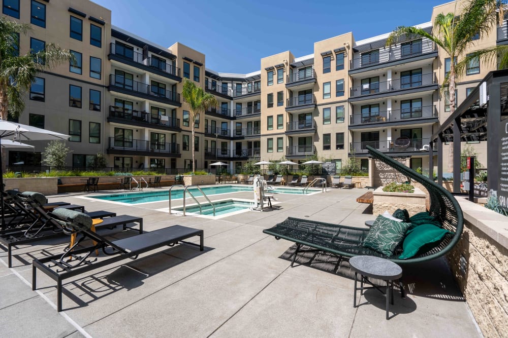 Resort-style pool with lounge seating at MV Apartments in Mountain View, California