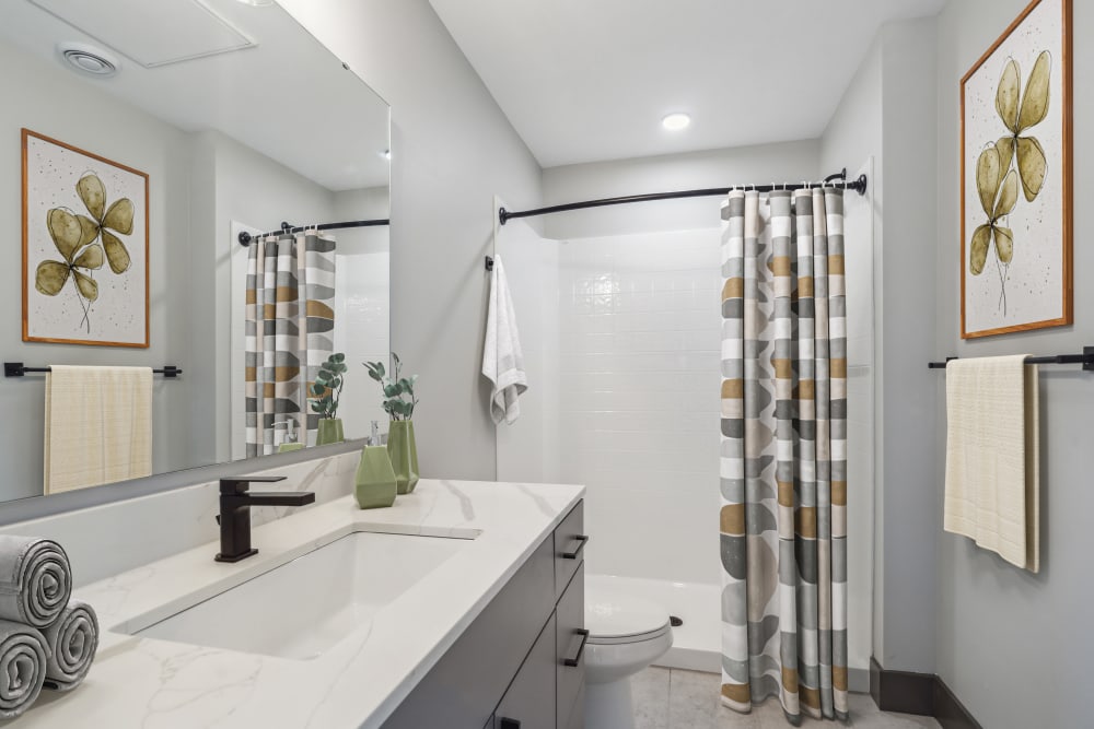 Bathroom with custom cabinetry and fixtures at Alta Crossing in Marysville, Washington