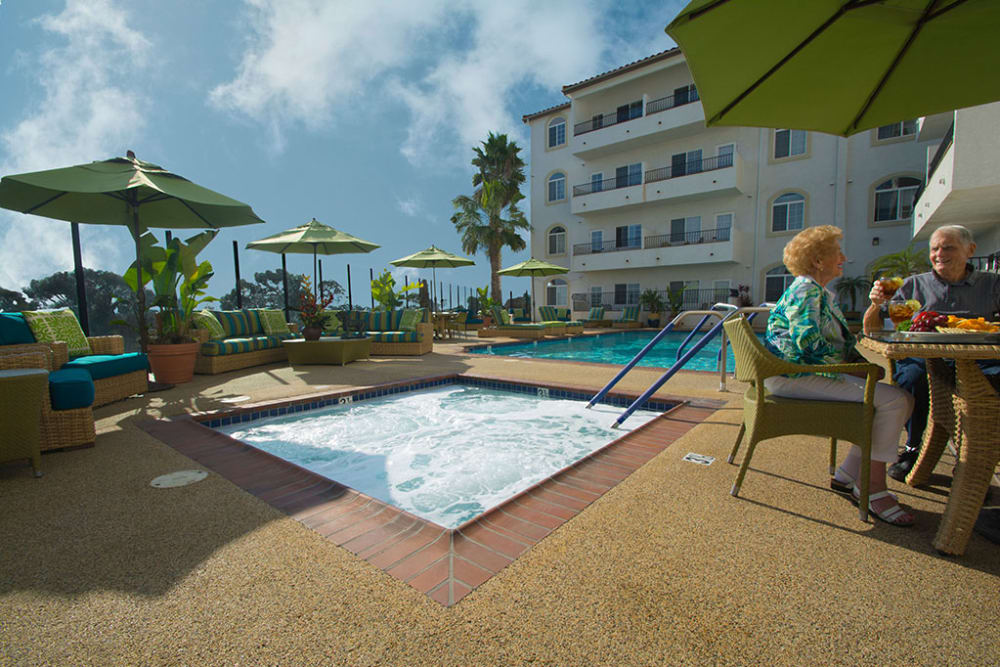 Residents enjoying breakfast by the pool at San Clemente Villas by the Sea in San Clemente, California