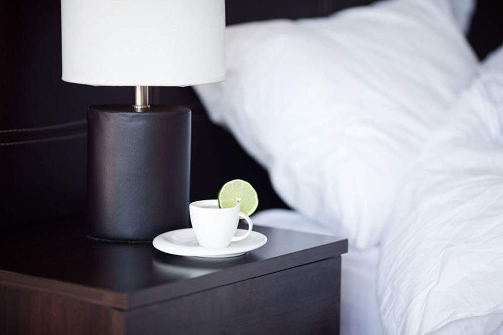 Tea cup sits beside the a bed at Ashlar Flats in Dublin, Ohio