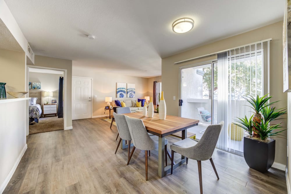 Table in dining area featuring sliding glass doors that lead to a private deck.