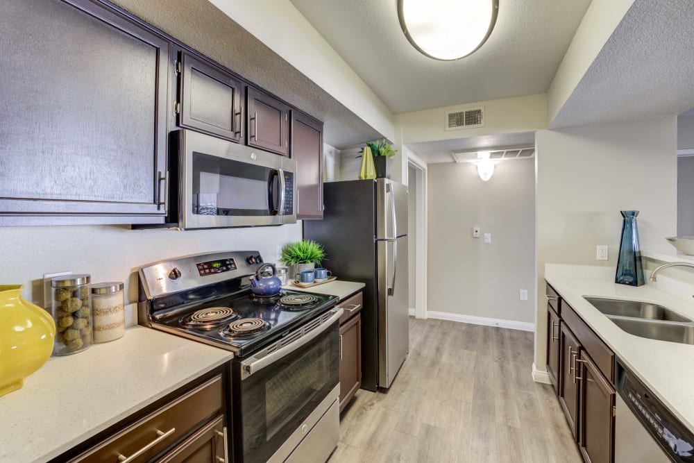 Kitchen with dark wood cabinets and ample countertop space at Ascent at Silverado in Las Vegas, Nevada