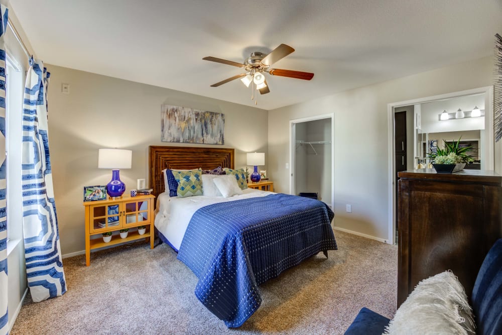 Modern bedroom featuring a ceiling fan in an apartment at Ascent at Silverado in Las Vegas, Nevada