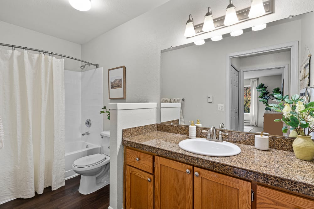 Bathroom with a spacious tub and marble countertops at Timbers at Tualatin in Tualatin, Oregon