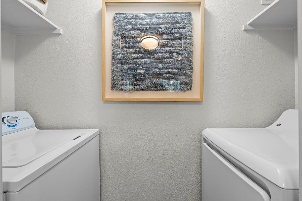 In-unit laundry room with washer and dryer on either side in a model home at Timbers at Tualatin in Tualatin, Oregon