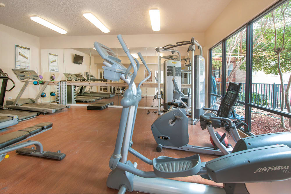 Resident gym with a large window at Ashley Oaks in San Antonio, Texas