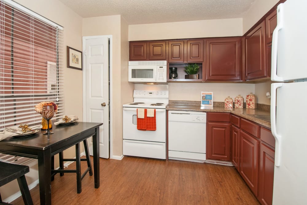 Model kitchen with wood cabinets at Ashley Oaks in San Antonio, Texas
