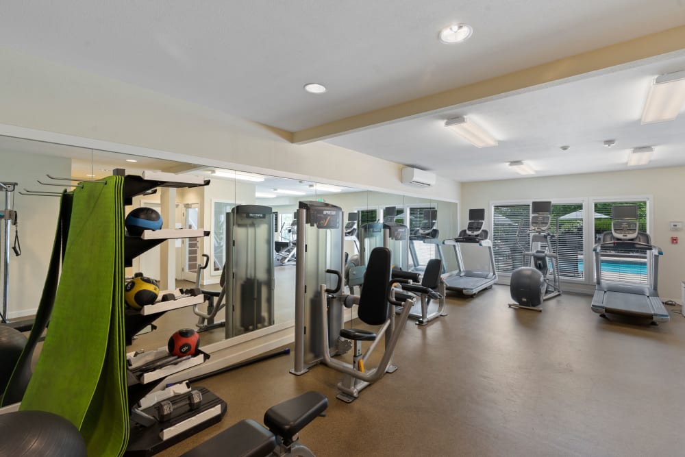 Large fitness center with various exercise equipment at Skyline Redmond in Redmond, Washington