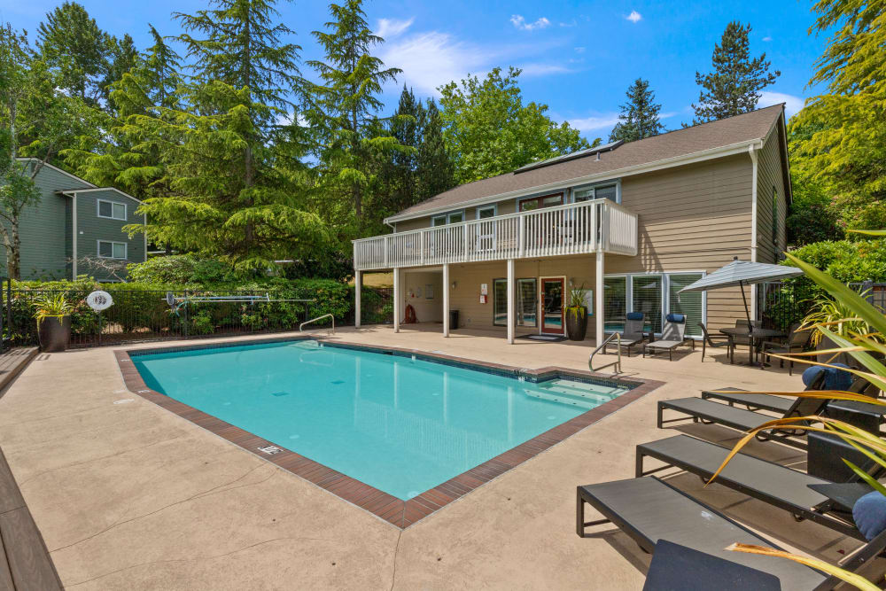 Community swimming pool with clubhouse in the background at Skyline Redmond in Redmond, Washington