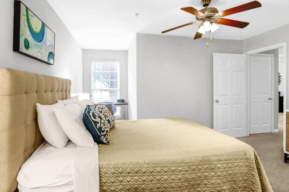 Model bedroom with yellow sheets at Heritage in Hillsborough, North Carolina