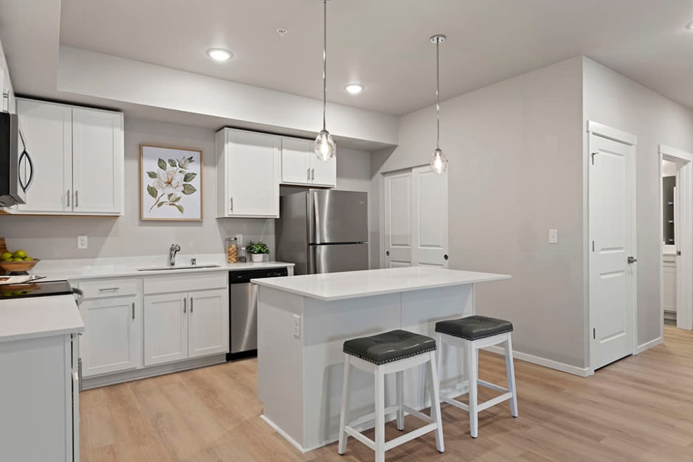 Modern kitchen with cabinets at Wyndstone Apartments in Yelm, Washington