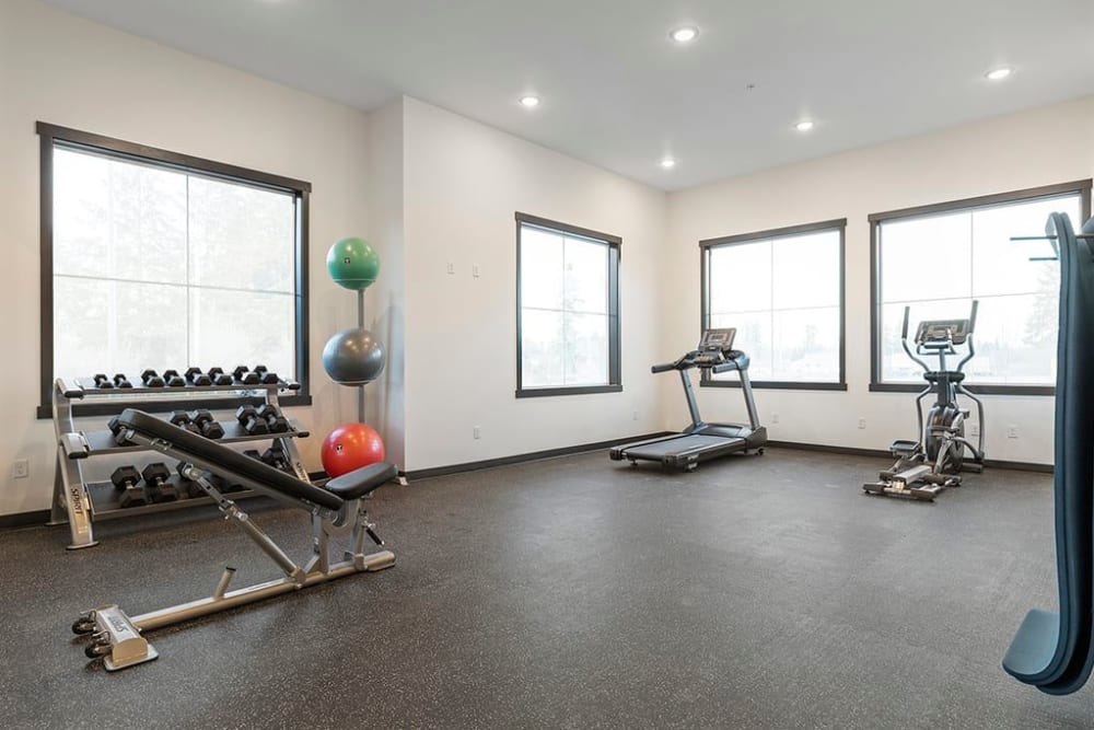 Cardio and weight lifting equipment in the fitness center at Wyndstone Apartments in Yelm, Washington