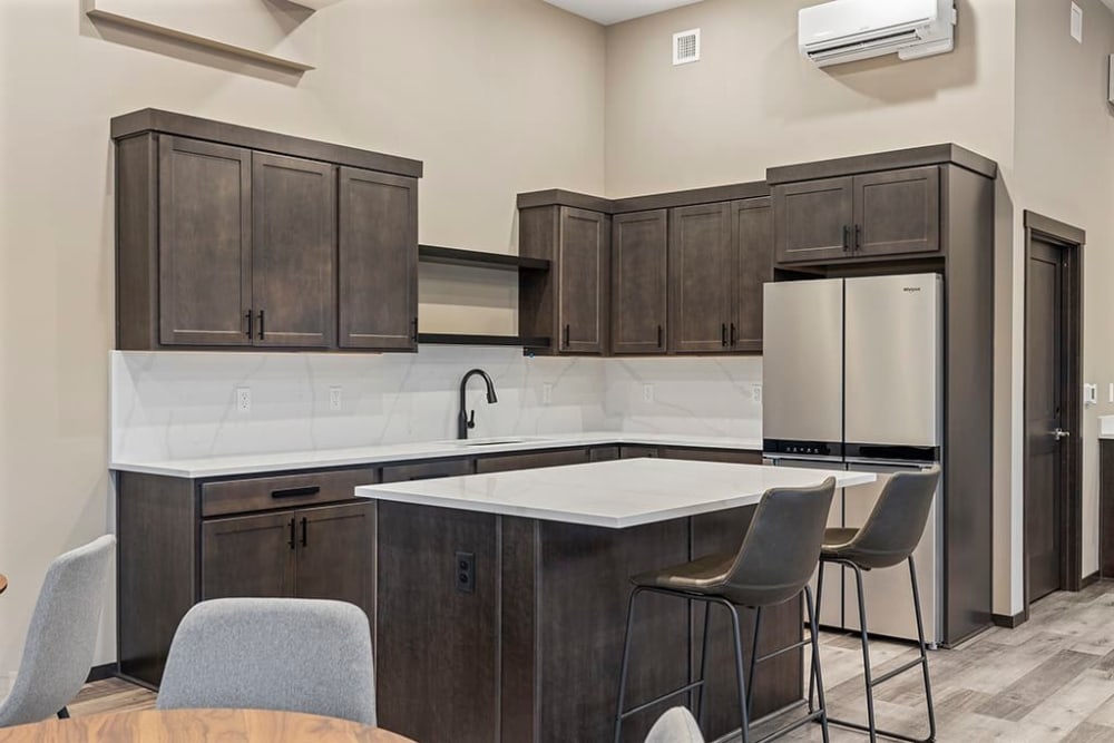 Clubhouse kitchen with cabinets at Wyndstone Apartments in Yelm, Washington