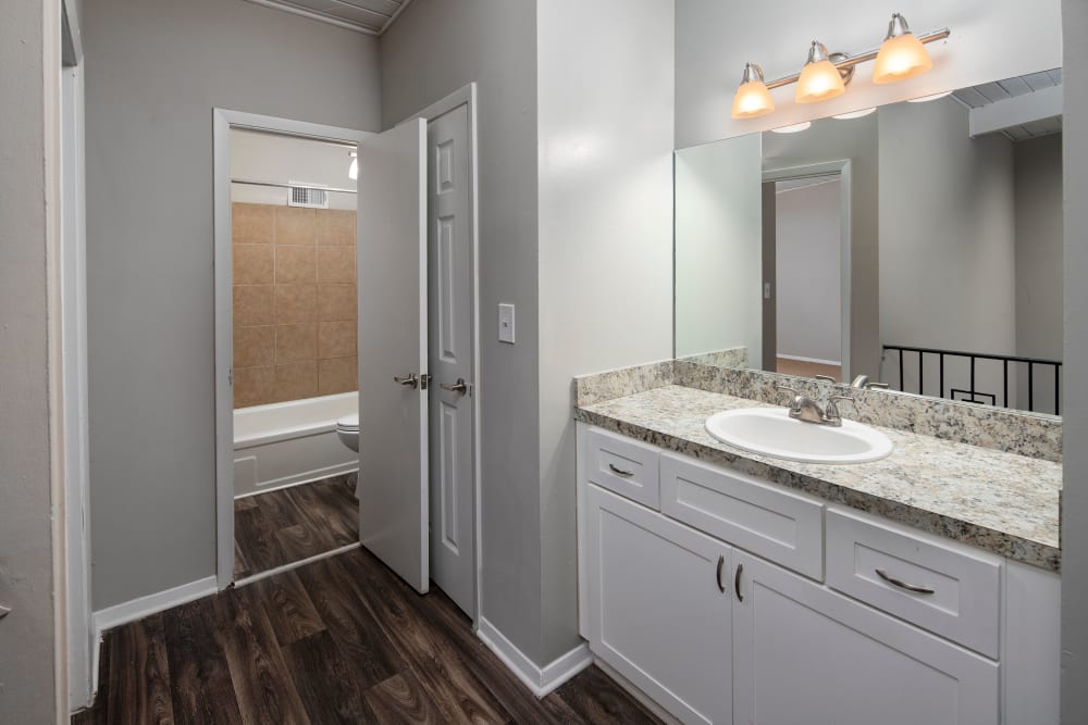 model bathroom with wood-style flooring at Parkside in Doraville, Georgia