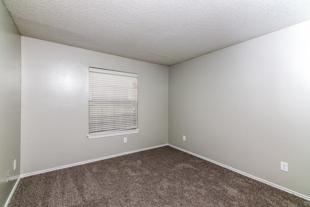 Bedroom with plush carpeting at Wythe Apartment Homes in Irving, Texas