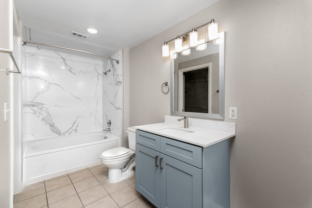 Bathroom with marble shower at Cleo Luxury Apartments in Dallas, Texas