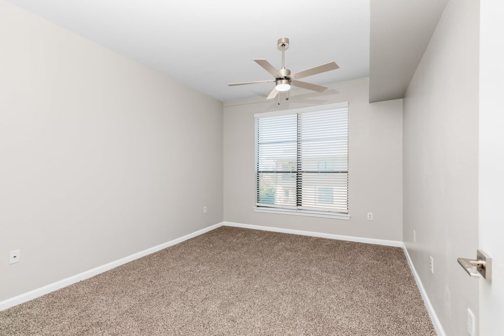 Bedroom with ceiling fan at Cleo Luxury Apartments in Dallas, Texas