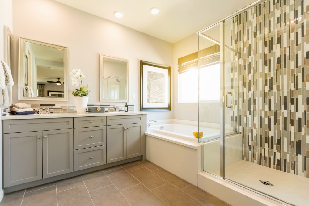 Full apartment bathroom with double vanity mirror at The Avenue at 3060 in Atlanta, Georgia