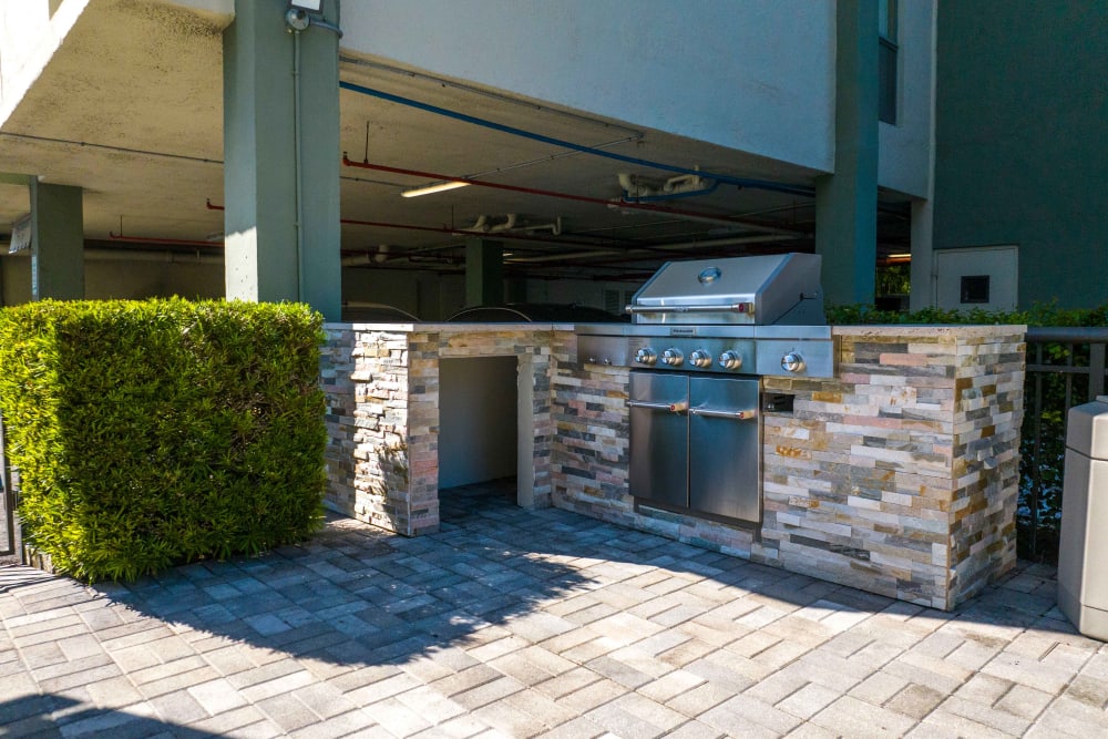 A grilling station beside the community pool at Forest Place in North Miami, Florida