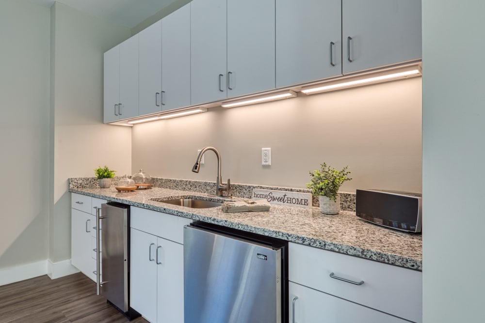 A community kitchen with counterspace and a dishwasher at Millspring Commons in Richmond, Virginia