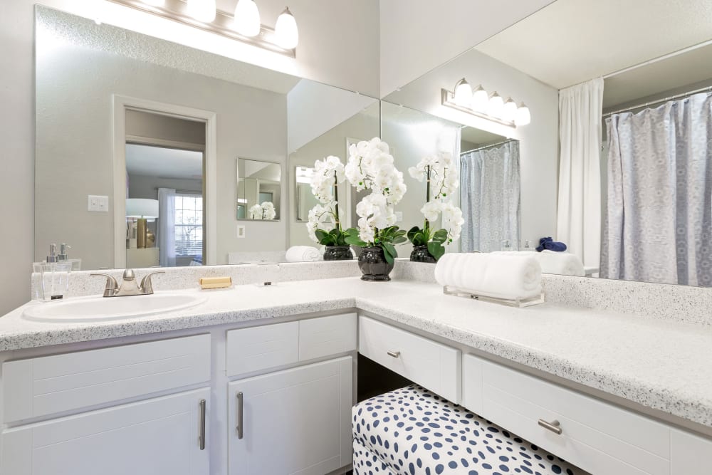 Bathroom with L-shaped counter and large mirrors in a model home at Parc at 1695 in Norcross, Georgia