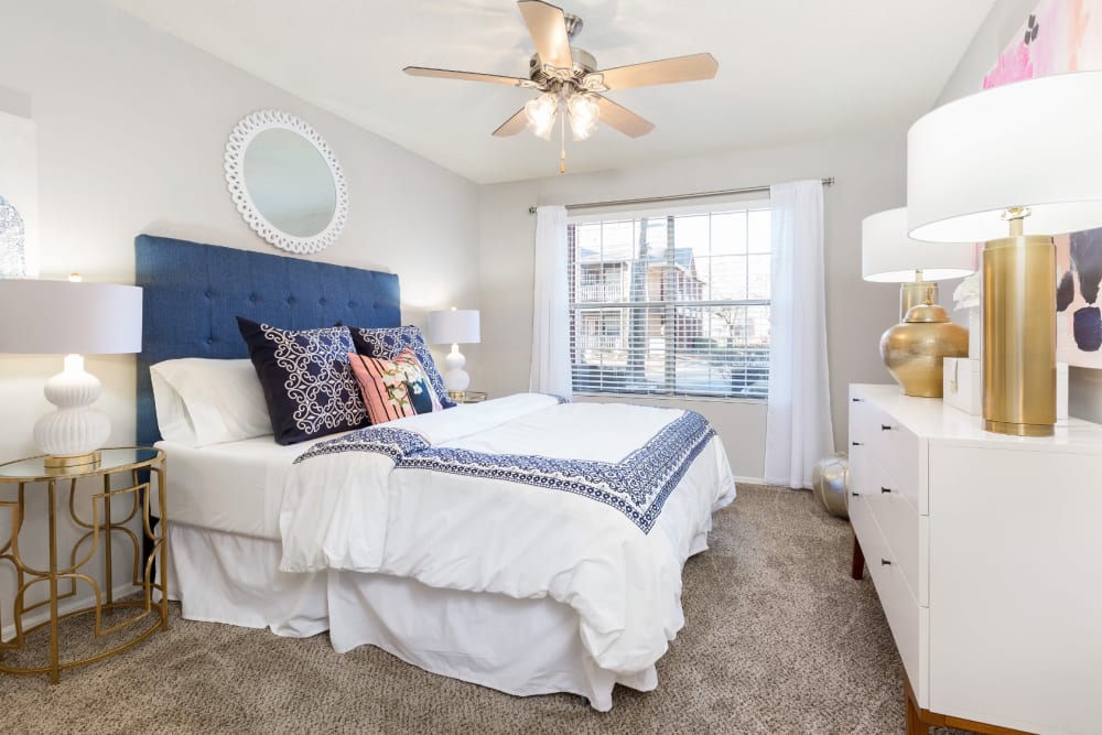 Cozy bedroom with a ceiling fan in a model home at Parc at 1695 in Norcross, Georgia