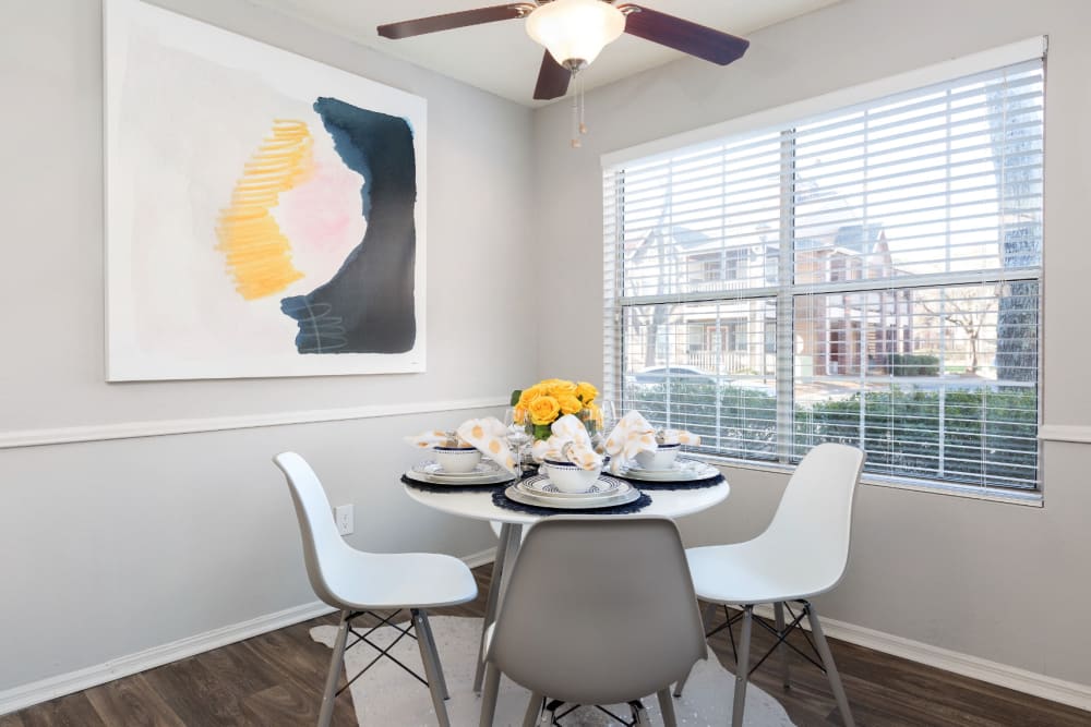 Dining area with plenty of natural lighting and a ceiling fan in a model home at Parc at 1695 in Norcross, Georgia
