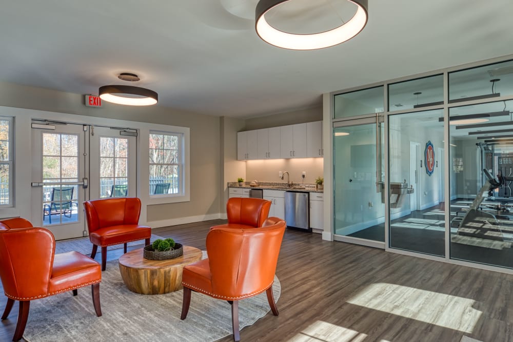 A seating area and glass doors to the fitness center at Millspring Commons in Richmond, Virginia