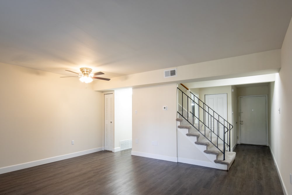 Wood flooring and a ceiling fan in an apartment living room at Millspring Commons in Richmond, Virginia