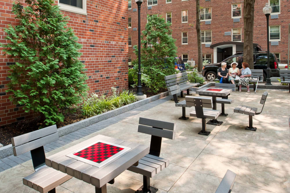 Courtyard with gaming tables at Camelot Court in Brighton, Massachusetts