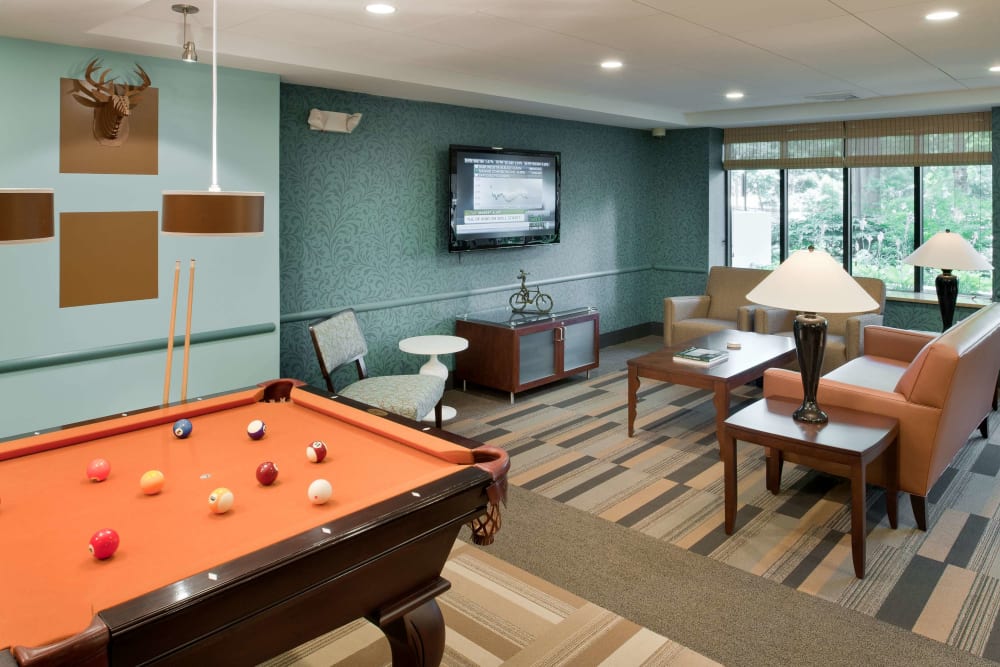 Community gathering space with a tv at Camelot Court in Brighton, Massachusetts