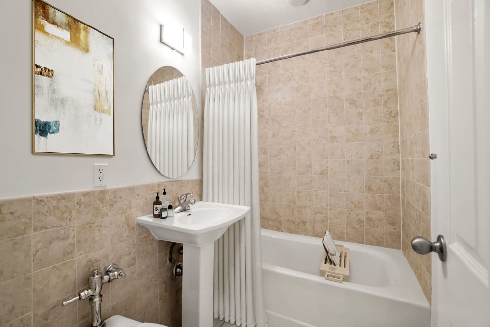 One bedroom bathroom with custom backsplash at Camelot Court in Brighton, Massachusetts