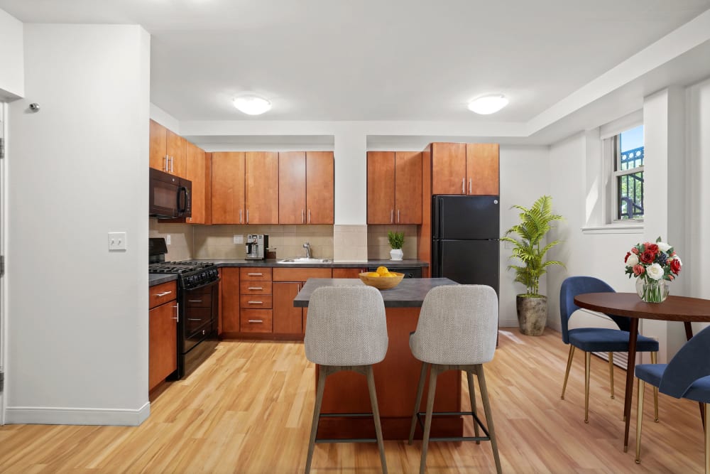 Two bedroom kitchen with black appliances at Camelot Court in Brighton, Massachusetts