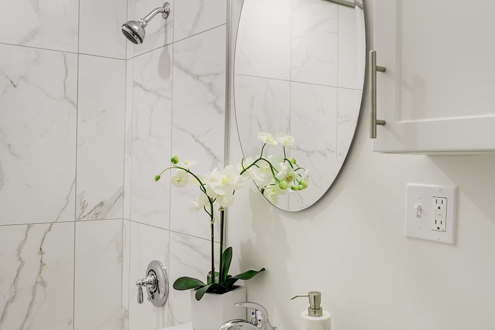 Three bedroom bathroom with custom backsplash at Camelot Court in Brighton, Massachusetts