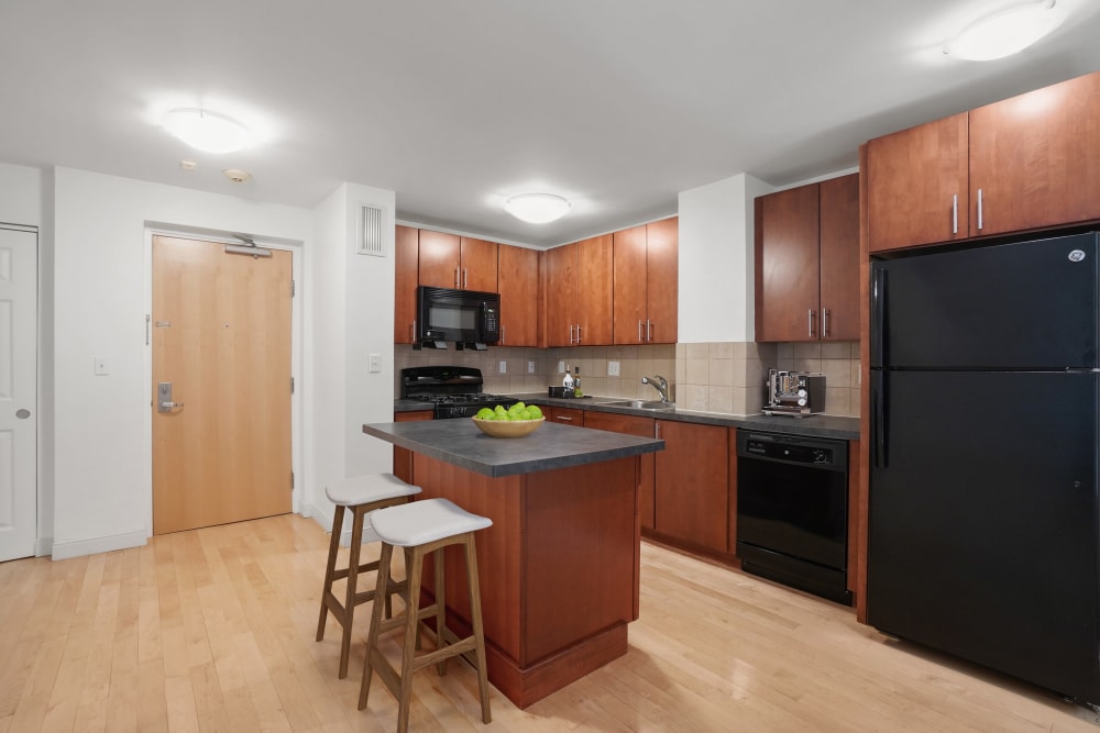 Three bedroom modern kitchen with a kitchen island at Camelot Court in Brighton, Massachusetts