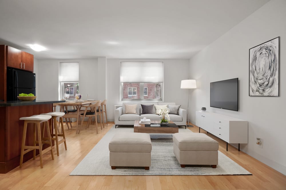 Three bedroom living space with wood-style flooring at Camelot Court in Brighton, Massachusetts