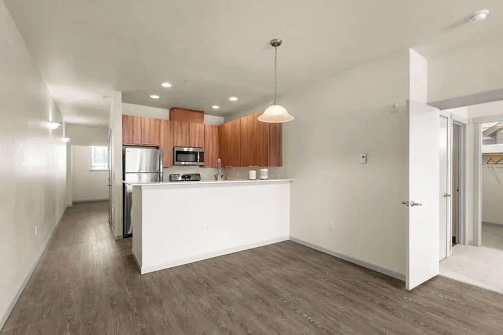 Beautifully finished hardwood flooring in a model apartment's living area at Bella on Canyon in Puyallup, Washington