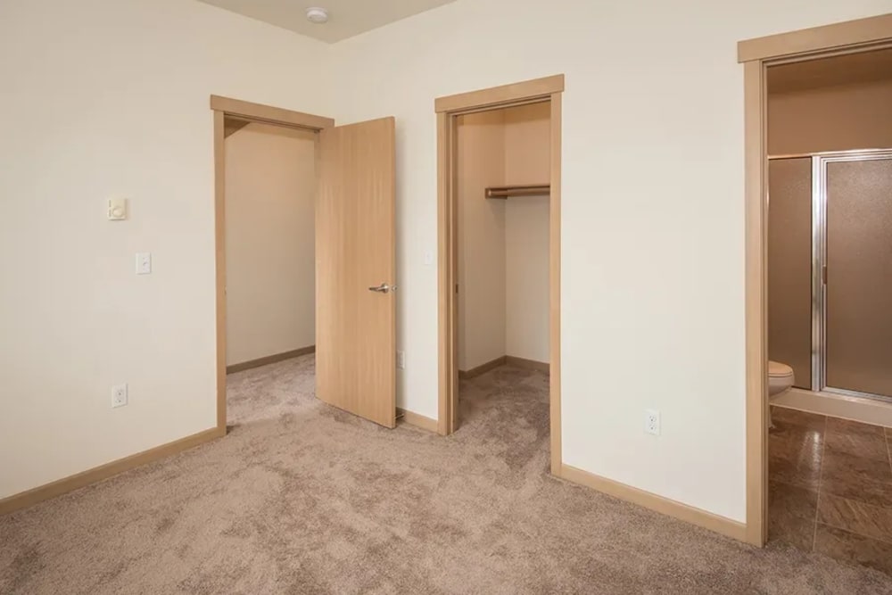Model bedroom with soft carpet at Bella on Canyon in Puyallup, Washington