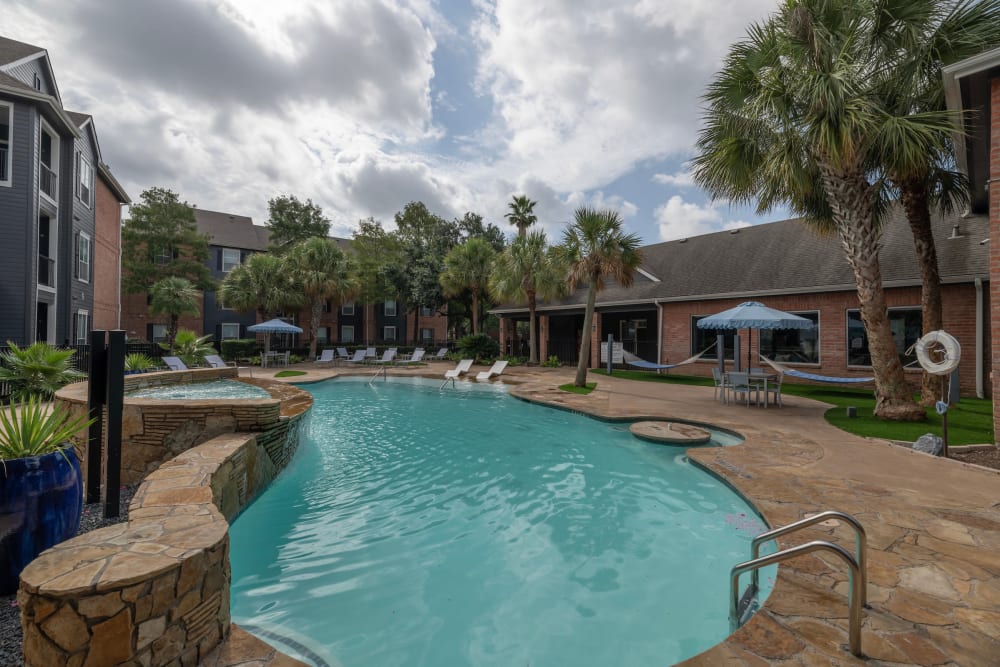 Poolside seating at Compass at Windmill Lakes in Houston, Texas