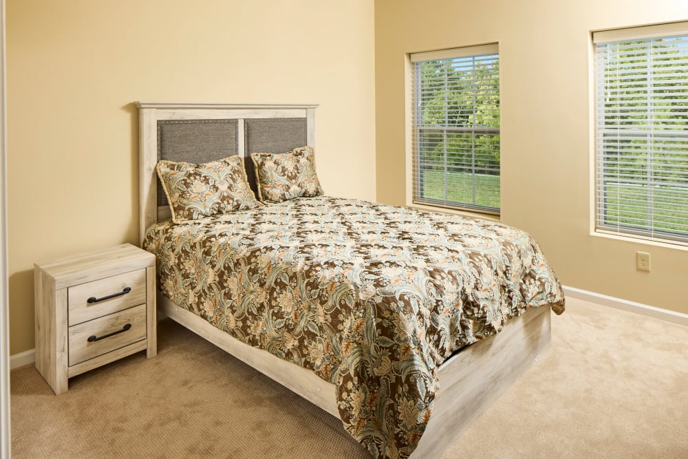 A comfortable apartment bedroom at Legacy Living Green Township in Cincinnati, Ohio