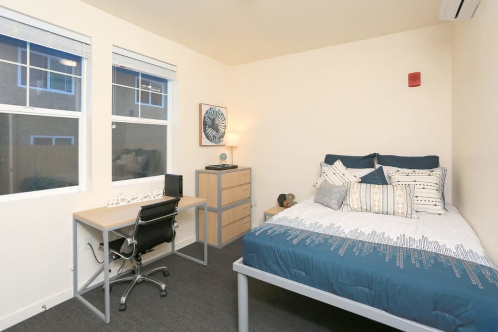 Bedroom with large windows at Cedar Flats in Chico, California