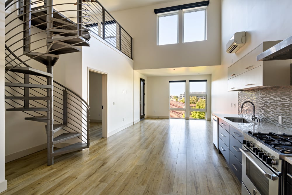 Open floor plan with wood-style flooring at 16 Powerhouse Apartments in Sacramento, California