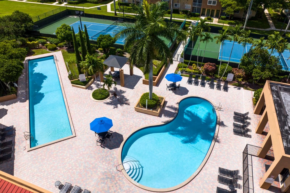Aerial view of the patio and two community pools at Azalea Village in West Palm Beach, Florida