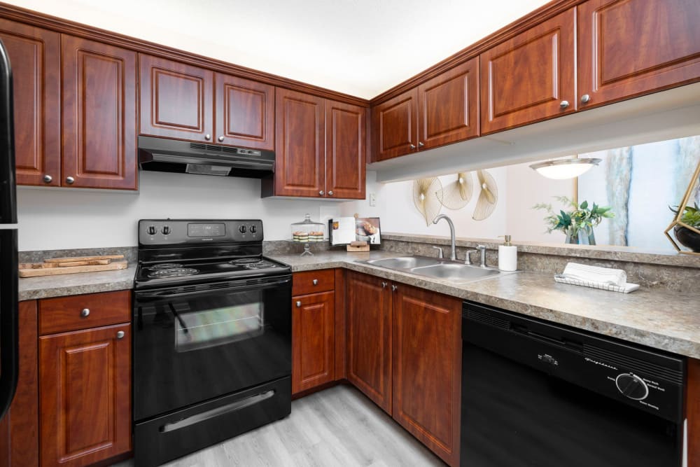 Cherry-colored cabinets in an apartment kitchen at Azalea Village in West Palm Beach, Florida