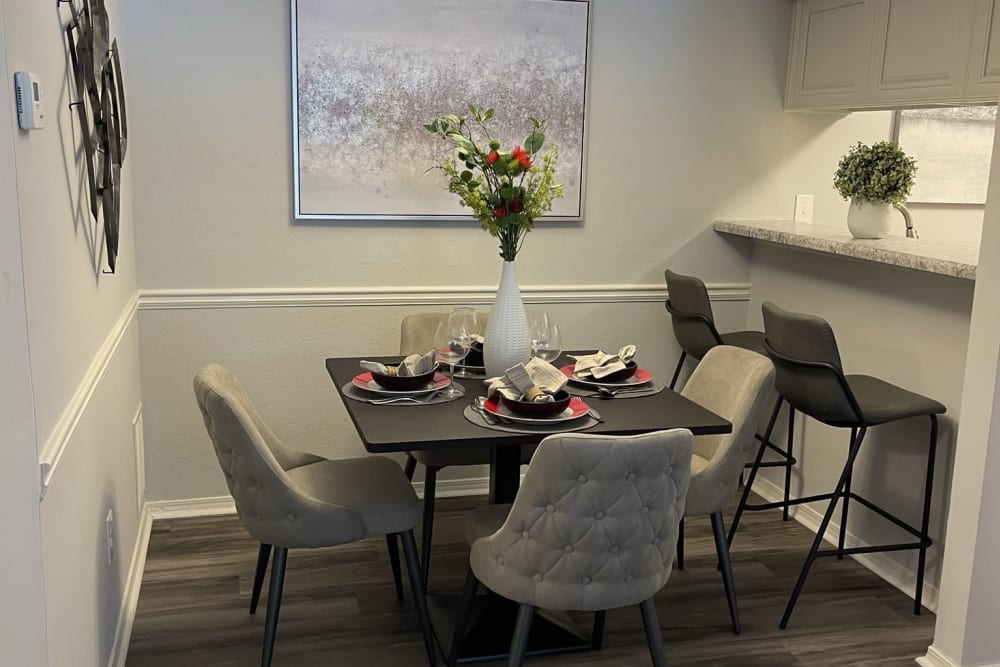 A dining room table and chairs in an apartment at Chapel Creek in Doraville, Georgia