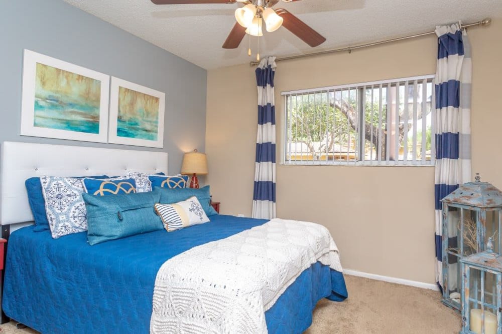A furnished bedroom with a king sized bed in an apartment at Fairway View in Hialeah, Florida