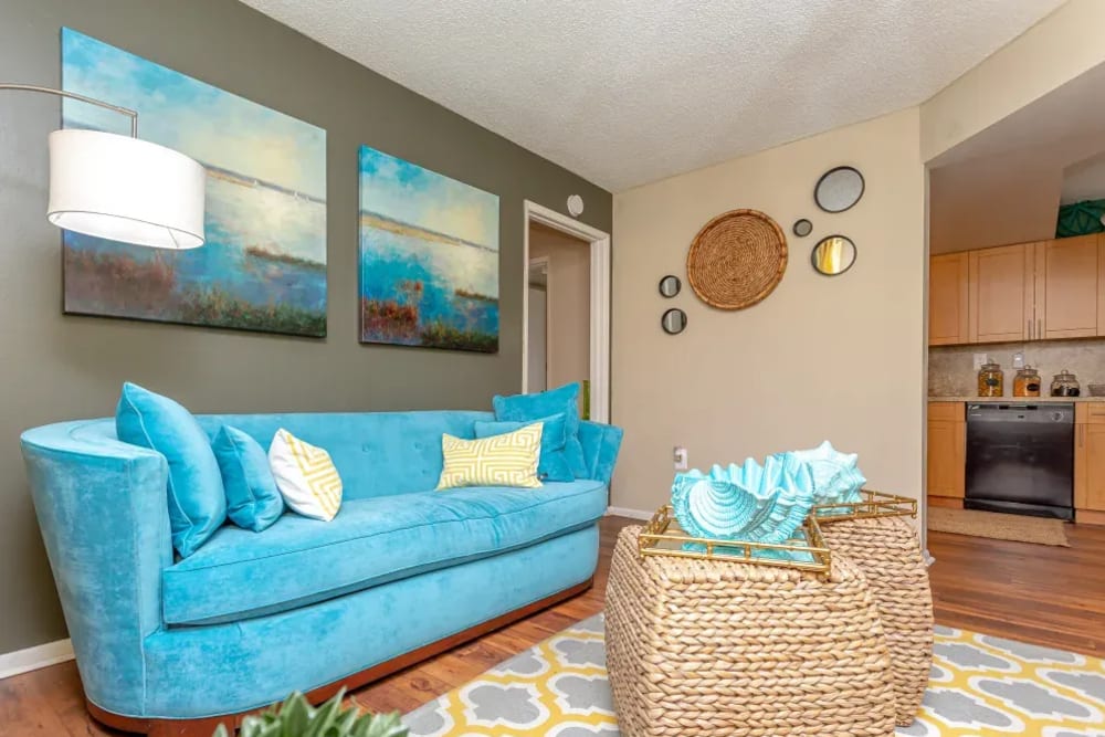 Wood flooring and an accent wall in a furnished apartment living room at Fairway View in Hialeah, Florida