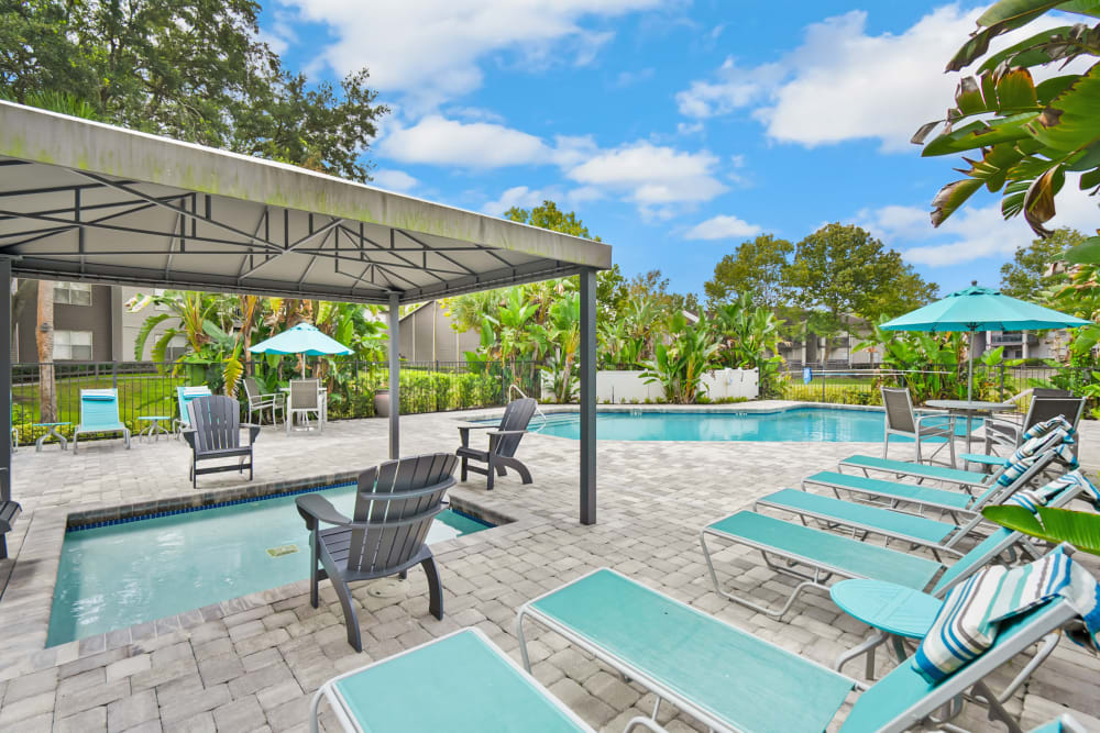Poolside lounge seating at The Isle Apartments in Orlando, Florida